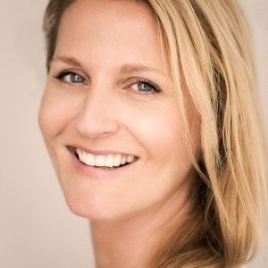 A person smiling for the camera

Description automatically generated