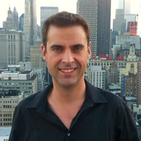 A person standing in front of a building

Description automatically generated