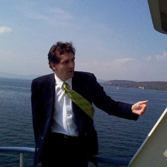 A person standing next to a body of water

Description automatically generated