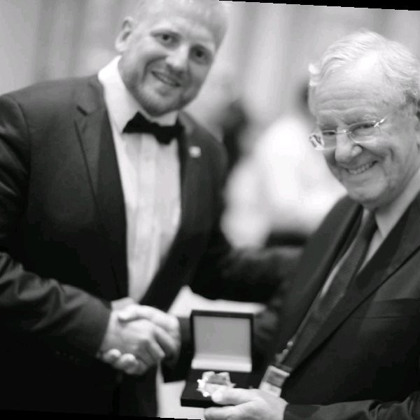 A person wearing a suit and tie

Description automatically generated